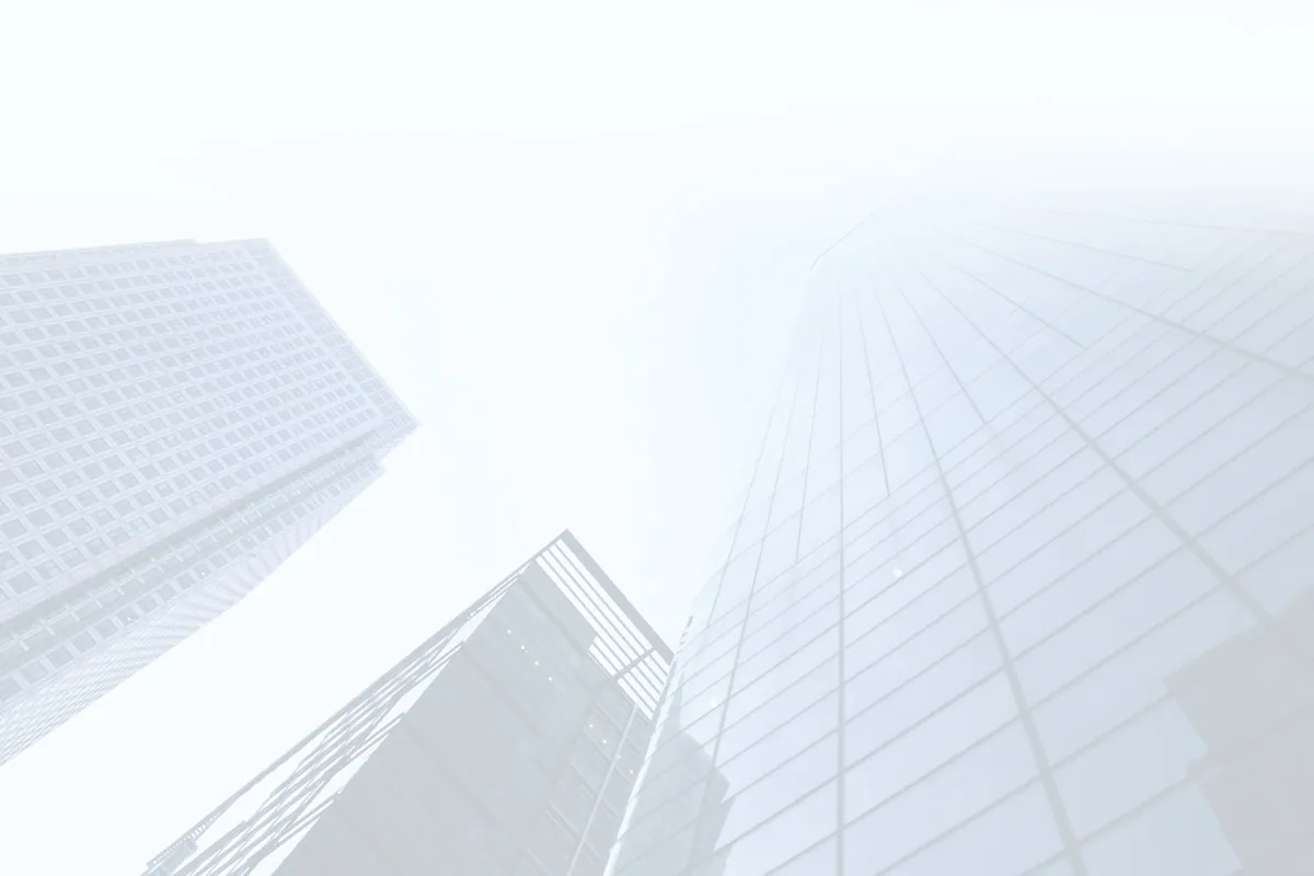 Corporate office buildings against a bright sky